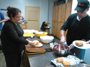 Power Up! participants Rachel Young and Bob Collins serve up a delicious meal to the Community Cafe patrons